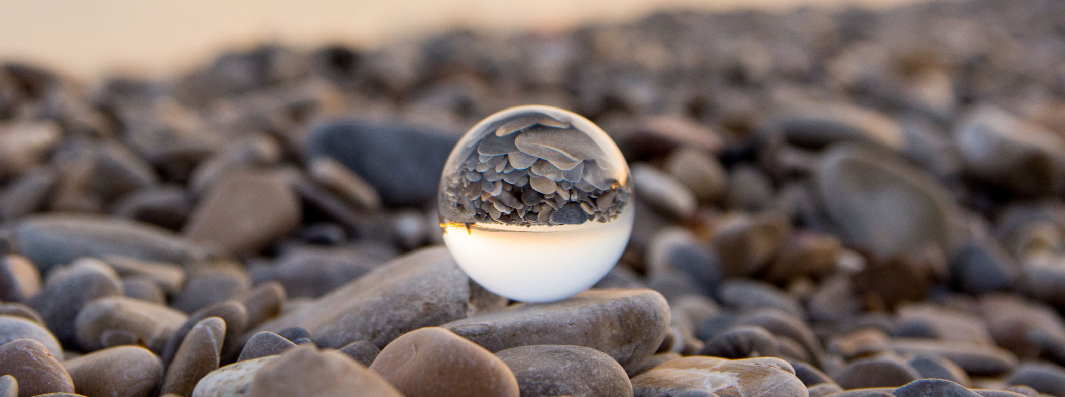 glass sphere on a rocky beach